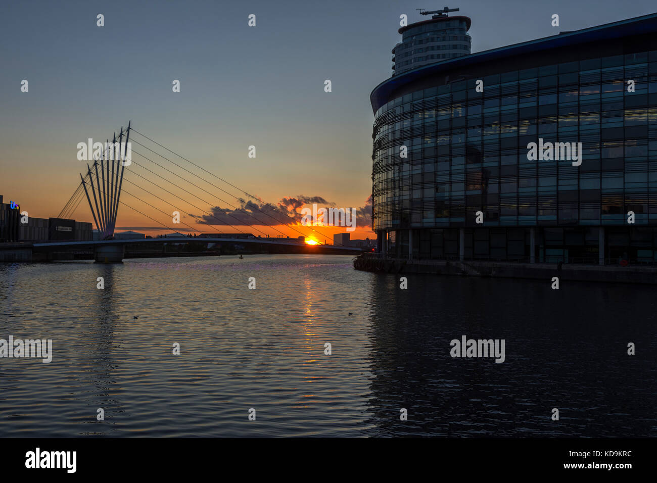 Sunset over the MediaCityUK swing bridge, MediaCityUK, Salford Quays, Manchester, England, UK Stock Photo