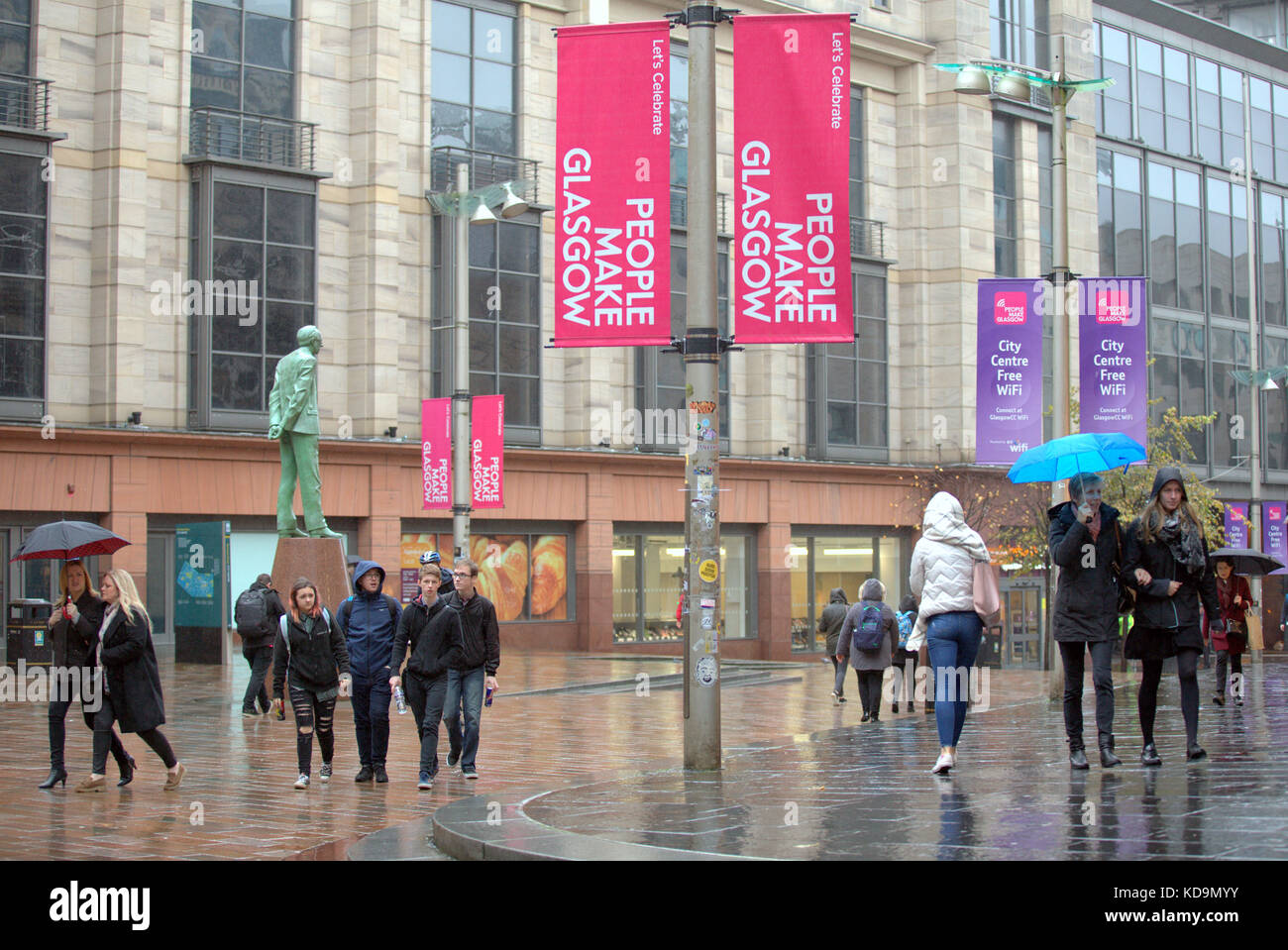 UK Weather The awful summer weather continues into autumn as Heavy showers and strong winds batter the city near the Donald Dewar statue on Buchanan Stock Photo