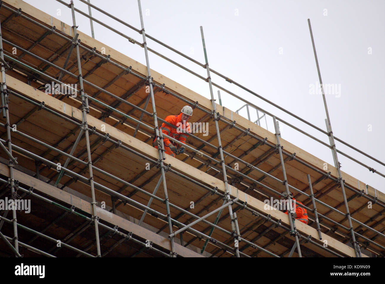 male man construction worker hard  hat on scaffolding sky copy space Stock Photo