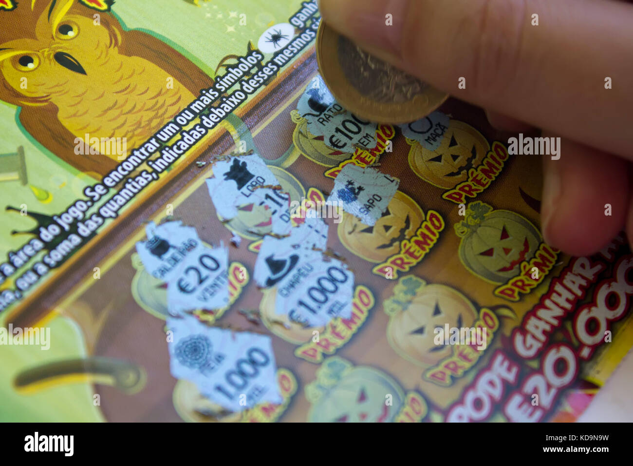 Scratching a Lottery Scratchcard with coin Stock Photo Alamy
