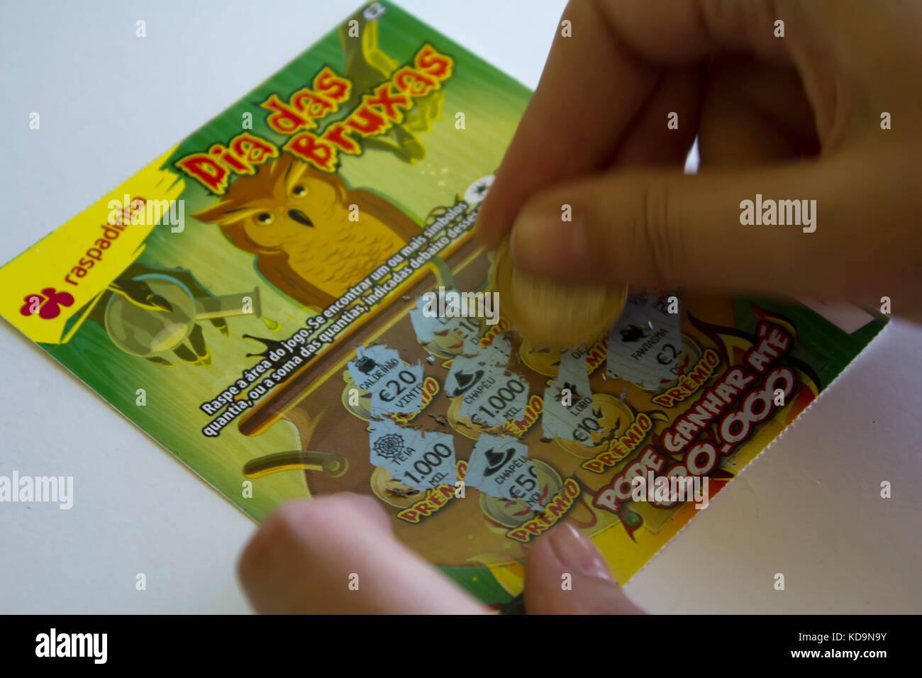 Scratching a Lottery Scratchcard with coin Stock Photo Alamy