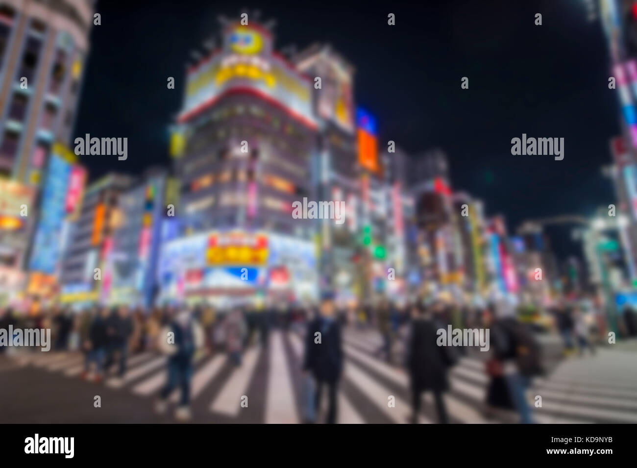 Blurred picture. People are crossing one of Japan's busiest crossroads in Shinjuko district at night. Shinjuku is a special ward in Tokyo, Japan. It i Stock Photo