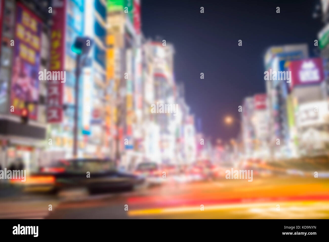 Blurred picture. Some taxi are passing in one of Japan's busiest crossroads in Shinjuko district at night. Shinjuku is a special ward in Tokyo, Japan. Stock Photo