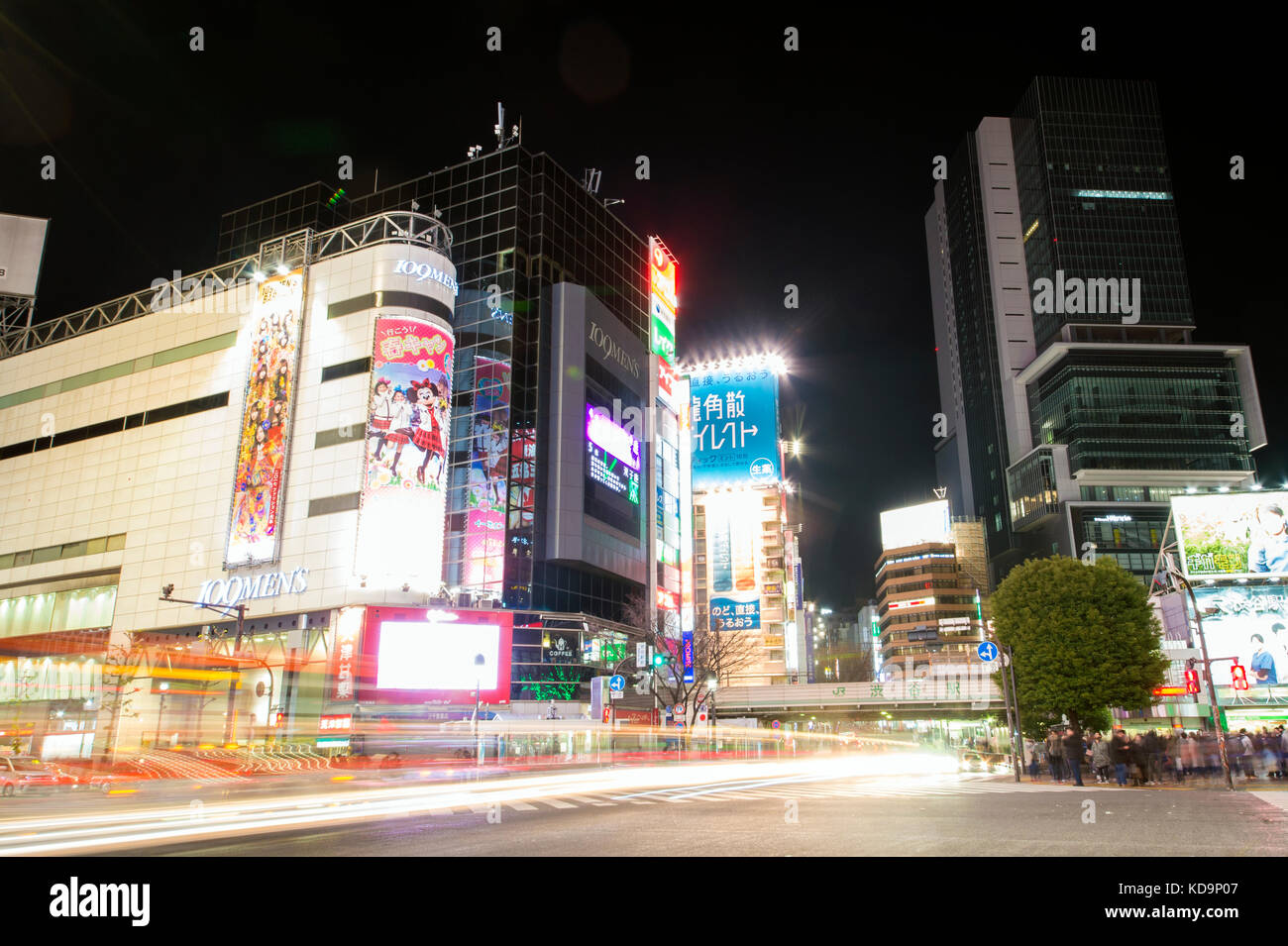 TOKYO - DECEMBER 31, 2016: Some cars are passing in one of Japan's busiest crossroads in Shinjuko district at night. Shinjuku is a special ward in Tok Stock Photo