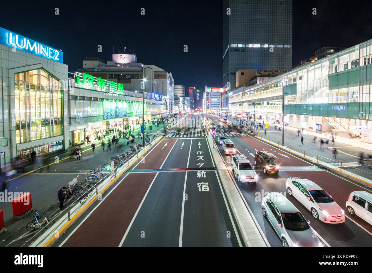 TOKYO - DECEMBER 31, 2016: Some cars are passing in one of Japan's busiest crossroads in Shinjuko district at night. Shinjuku is a special ward in Tok Stock Photo