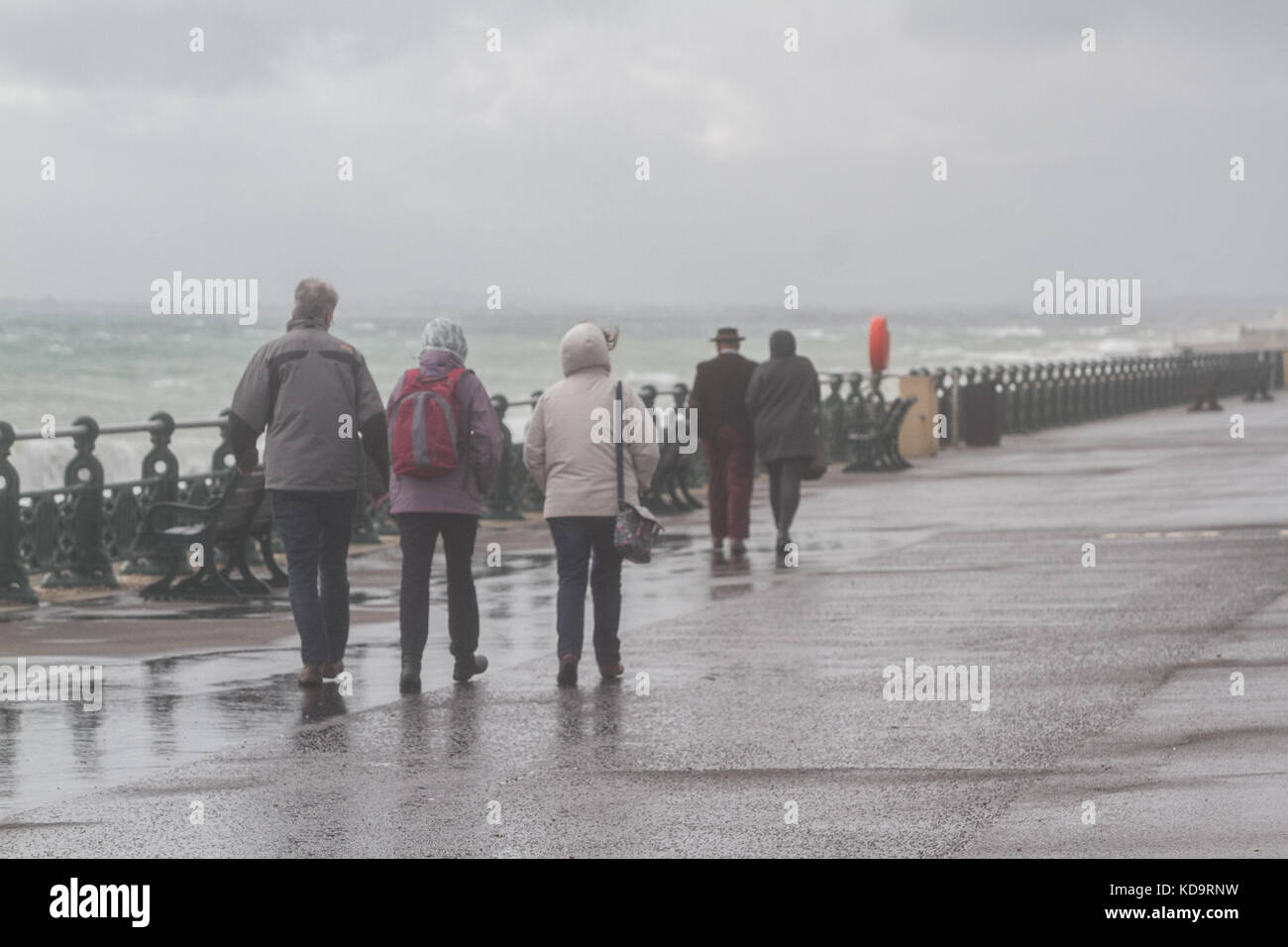 Brighton Sussex. 11th October 2017. People brave the bluster conditions and rain on Brighton seafront as the remains of Hurricane Nate from the mid altlantic is expected to batter parts of Britain Credit: amer ghazzal/Alamy Live News Stock Photo