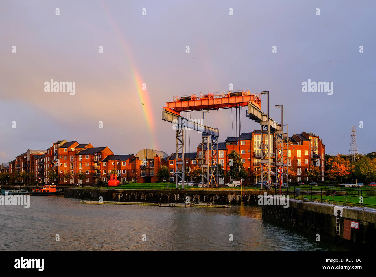 Preston, UK. 11th October 2017. UK Weather. After a wet day in Lancashire, the sun appeared briefly before sunset, creating a rainbow over Preston's Albert Dock.  The dock celbrated its 125th birthday this year and when built was the largest single dock in Europe. Credit: Paul Melling/Alamy Live News Stock Photo