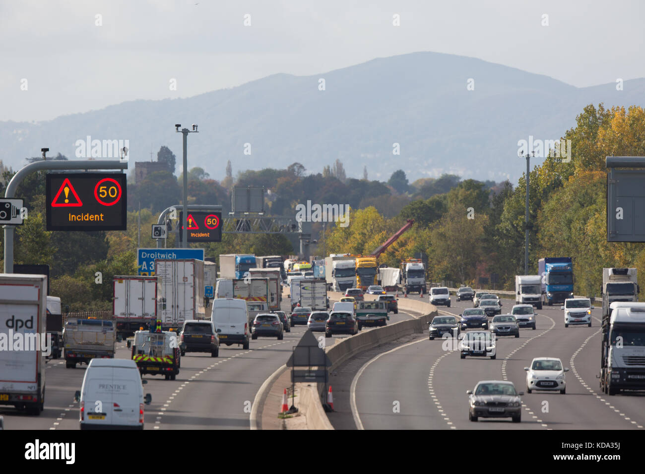 Droitwich, UK. 12th Oct, 2017. Recovery vehicles on the scene at UK M5 motorway, near Droitwich, rescuing HGV lorry from embankment. Traffic delays continue. Credit: Lee Hudson/Alamy Live News Stock Photo