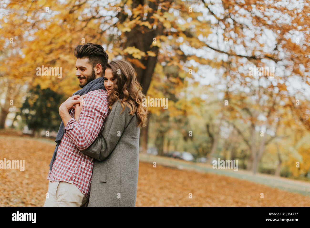 Young couple in love in the autumn forest Stock Photo - Alamy
