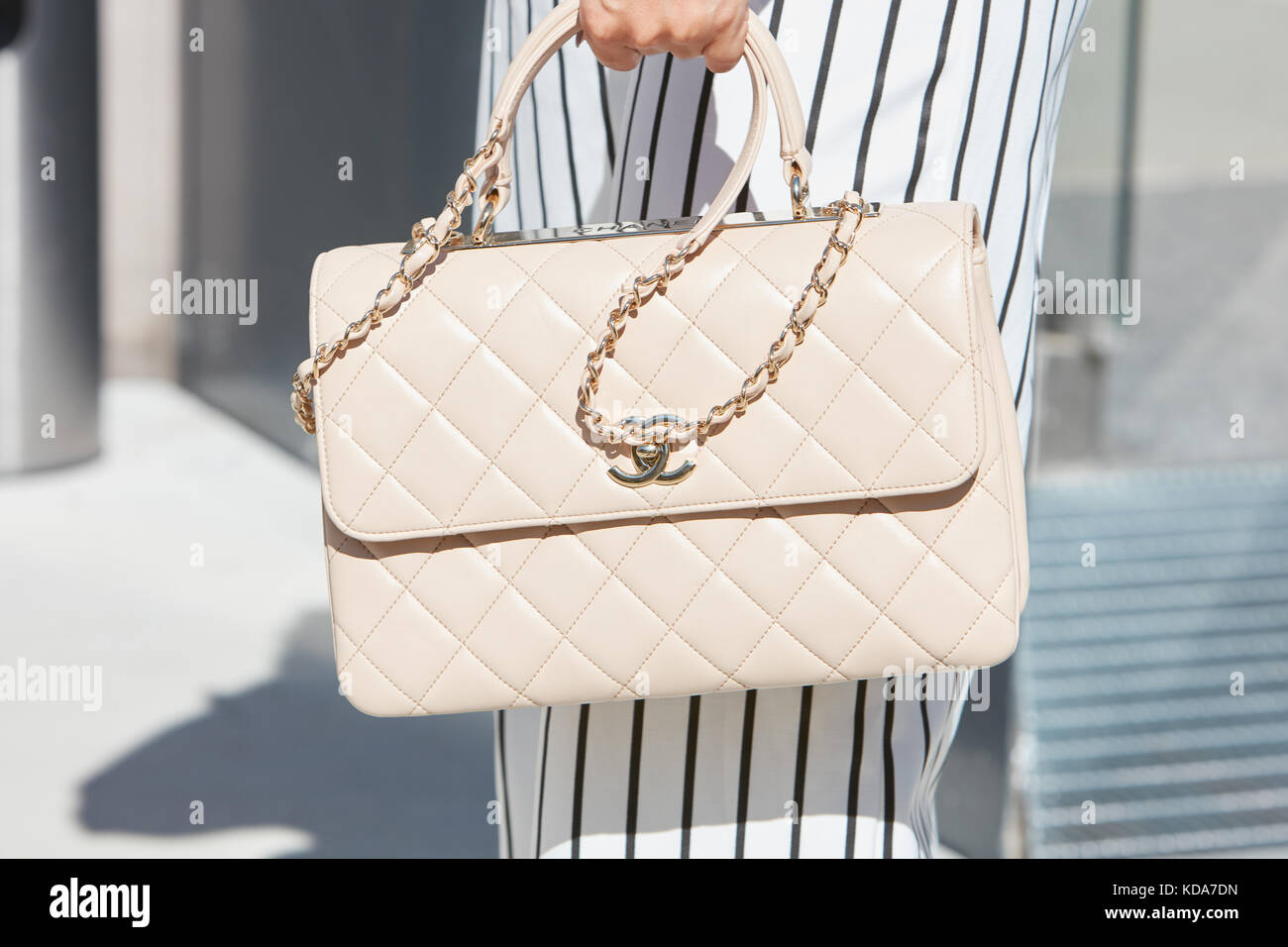 MILAN - SEPTEMBER 20: Woman with pale pink Chanel leather bag and