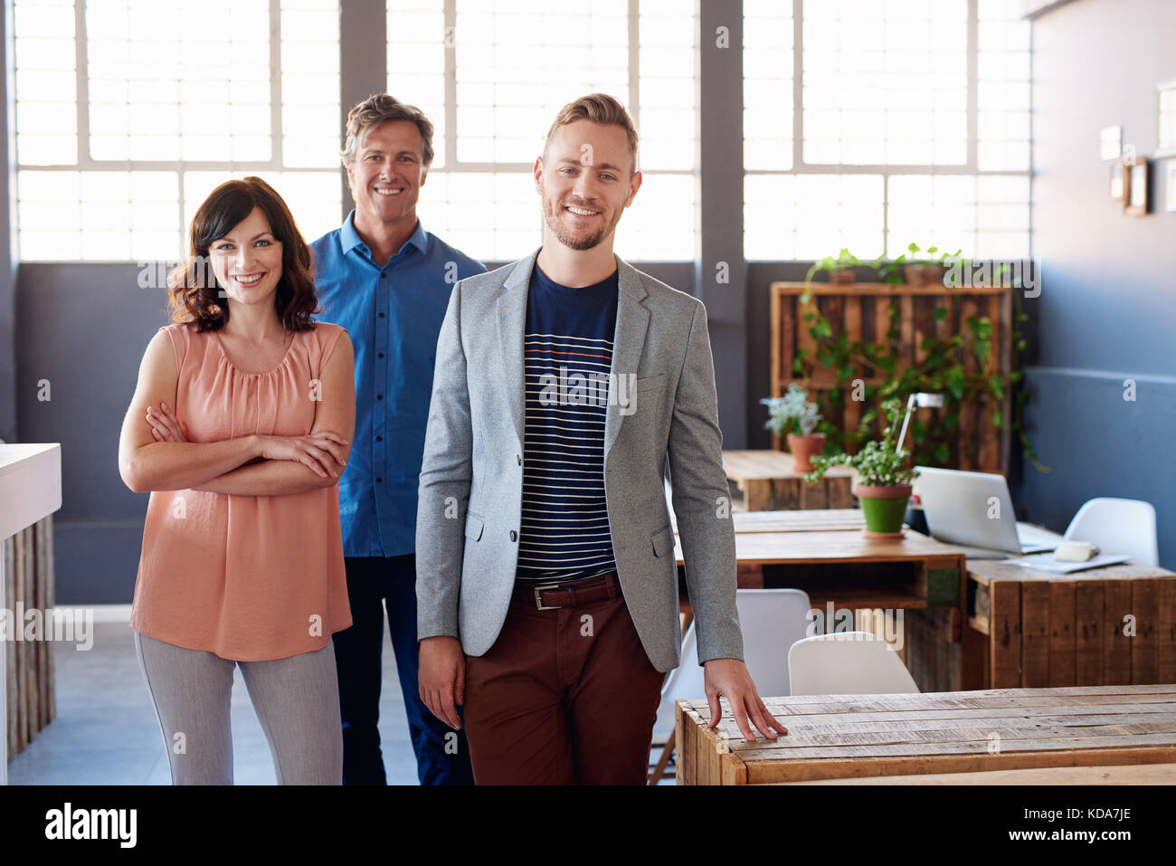 Confident business colleagues standing together in a modern office ...