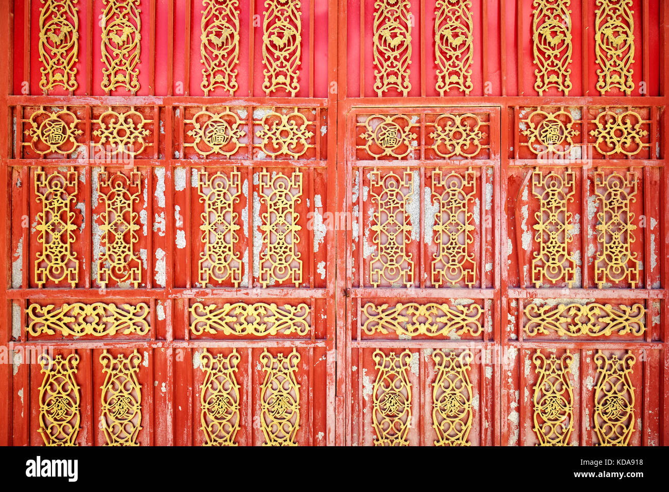 Old oriental iron door with peeling paint, China. Stock Photo