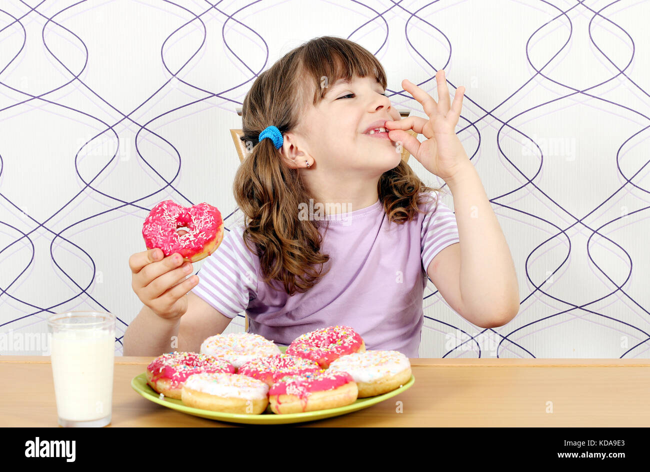 little girl enjoy sweet donuts Stock Photo