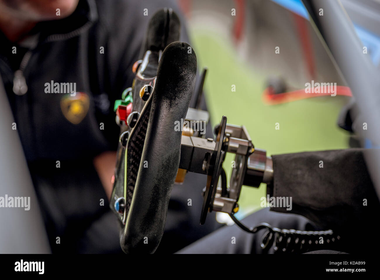 Black racing car steering wheel closeup selective focus motorsport concept driver cockpit Stock Photo