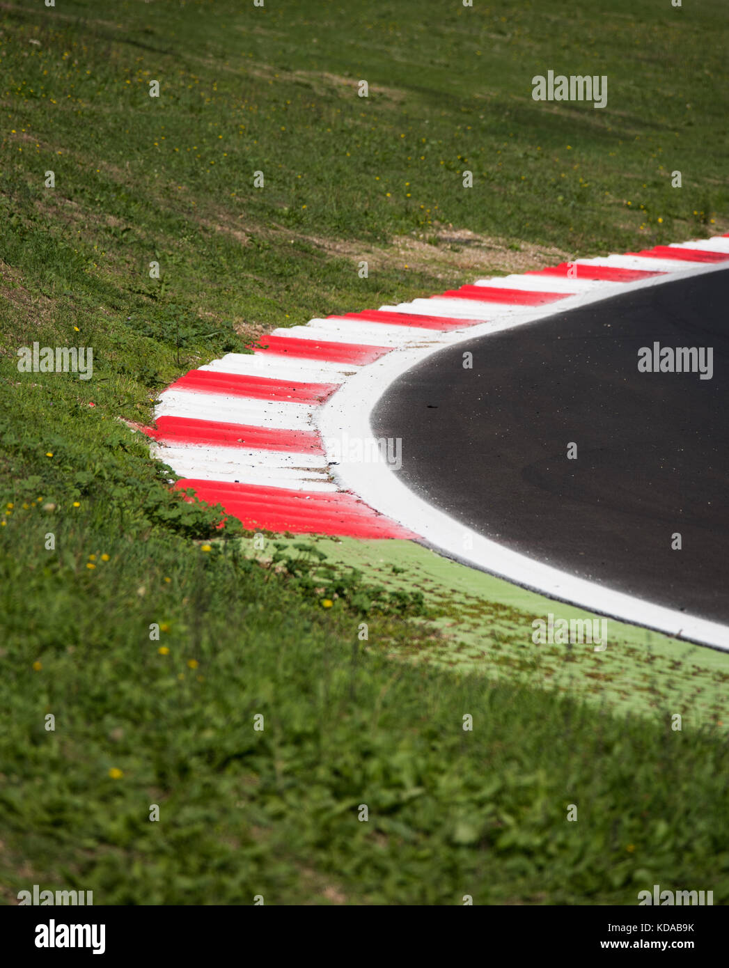 Concept of borderline, boundary, limit. Motorsport racing asphalt track round with red curb detail Stock Photo