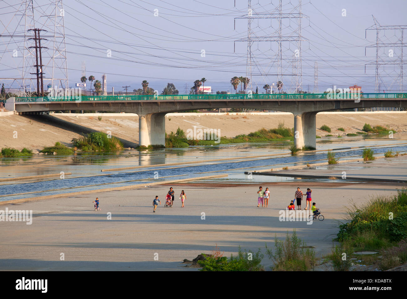 Residents keeping cool on a hot Summer evening by walking along the Los Angeles River, Bell, Los Angeles County, California, USA Stock Photo