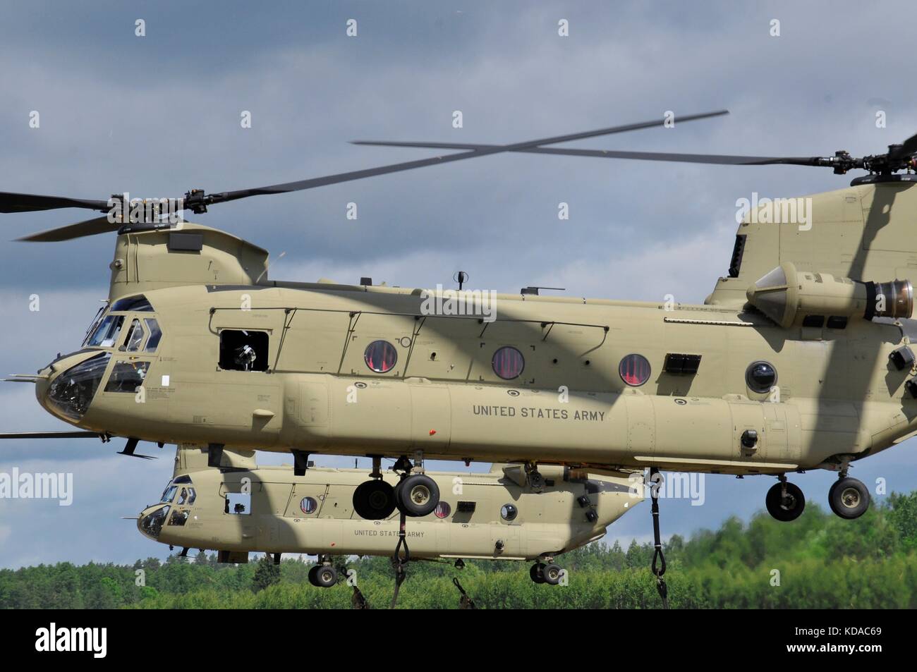 U.S. and Polish soldiers use U.S. Army CH-47 Chinook helicopters to sling-load M777 Howitzer artillery weapons at the Bemowo Piskie Training Area during exercise Saber Strike June 7, 2017 in Bemowo Piskie, Poland. Stock Photo