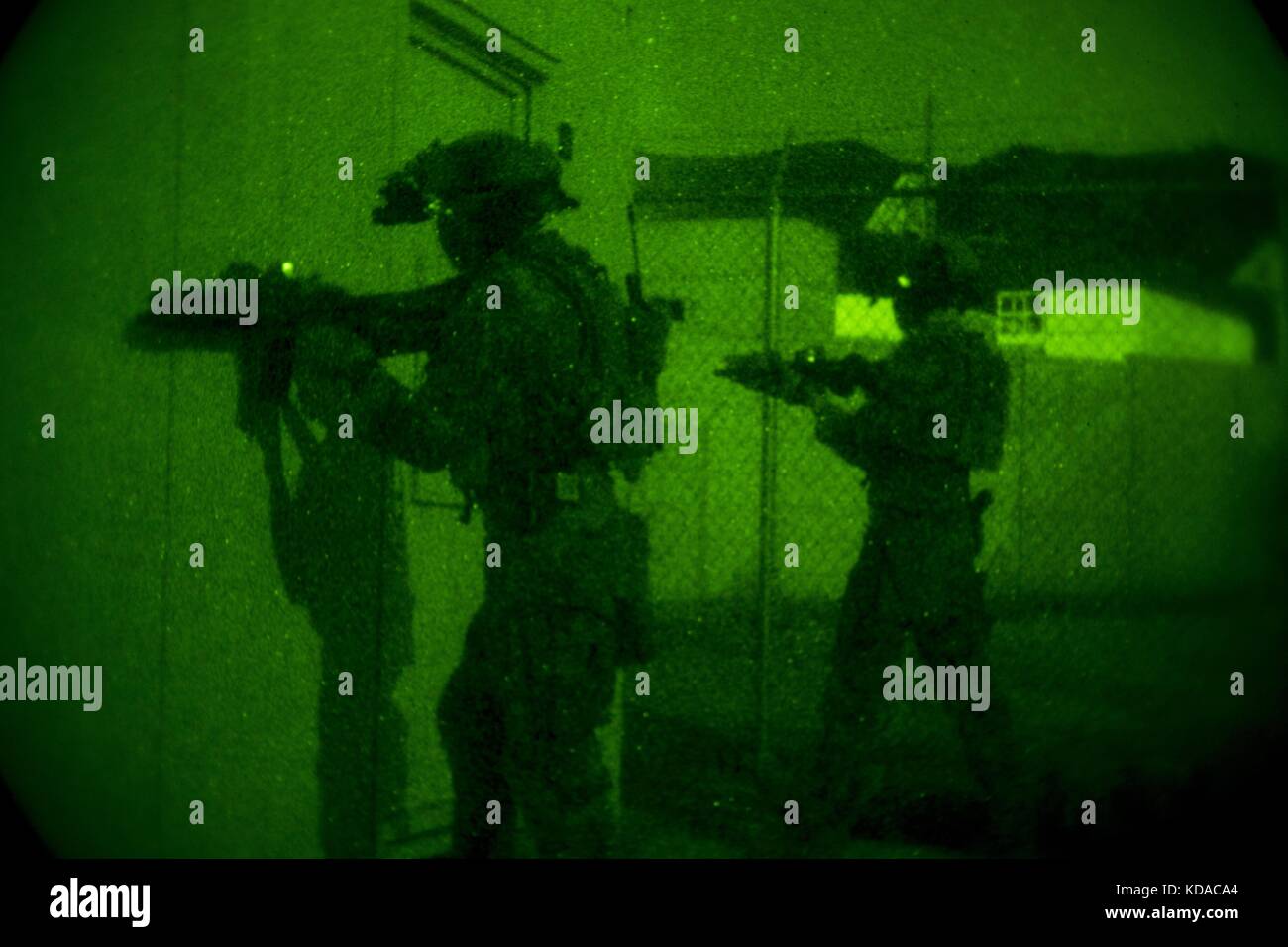 U.S. Marine Corps soldiers provide security through night vision goggles during visit, board, search and seizure training for the Company Collective Exercise at the Marine Corps Base Camp Pendleton October 15, 2015 in San Diego, California. Stock Photo