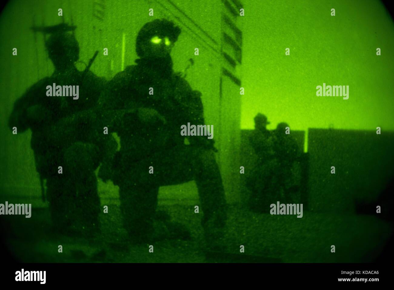 U.S. Marine Corps soldiers provide security through night vision goggles during visit, board, search and seizure training for the Company Collective Exercise at the Marine Corps Base Camp Pendleton October 15, 2015 in San Diego, California. Stock Photo