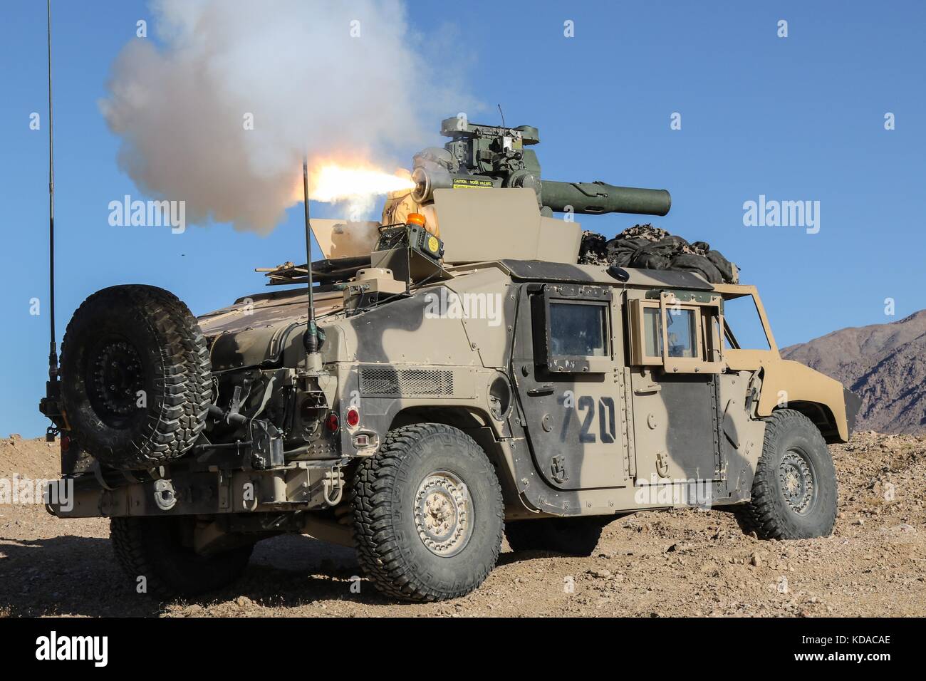 A U.S. Army Humvee tactical vehicle fires a simulated tube-launched, optically-tracked, wire-guided missile during an attack training scenario at the Fort Irwin National Training Center May 7, 2017 in Fort Irwin, California. Stock Photo