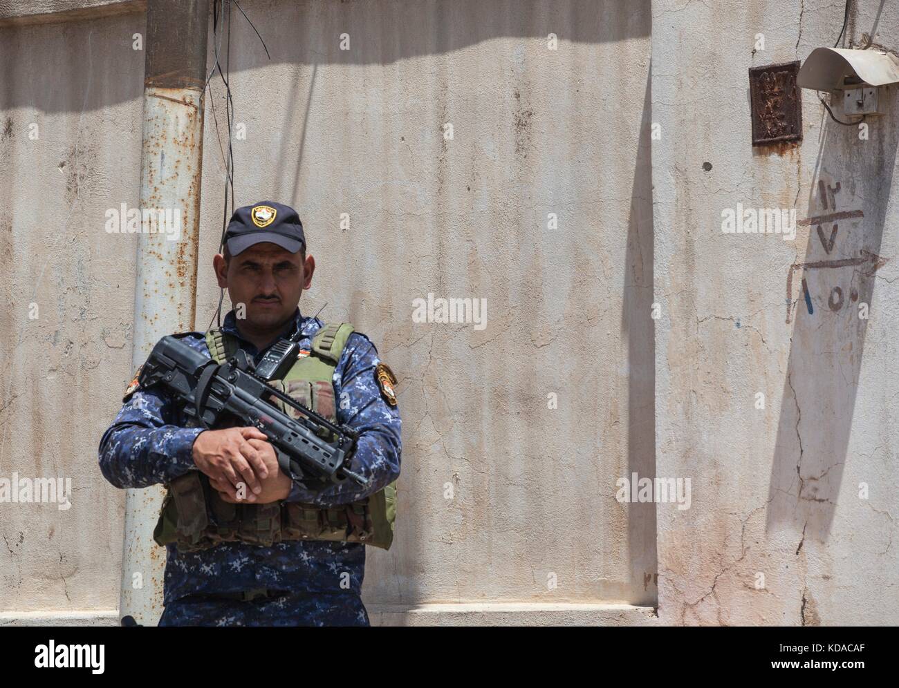 An Iraqi Federal Police officer guards a patrol base June 29, 2017 in Mosul, Iraq. There has been a combined effort between U.S. and Iraqi forces in the area to defeat ISIS extremists. Stock Photo