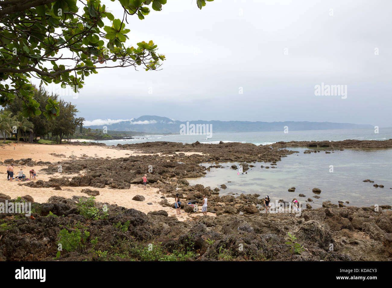 Tourists explore Sharks Cove, a beach along the North Shore of Oahu, Hawaii. Stock Photo