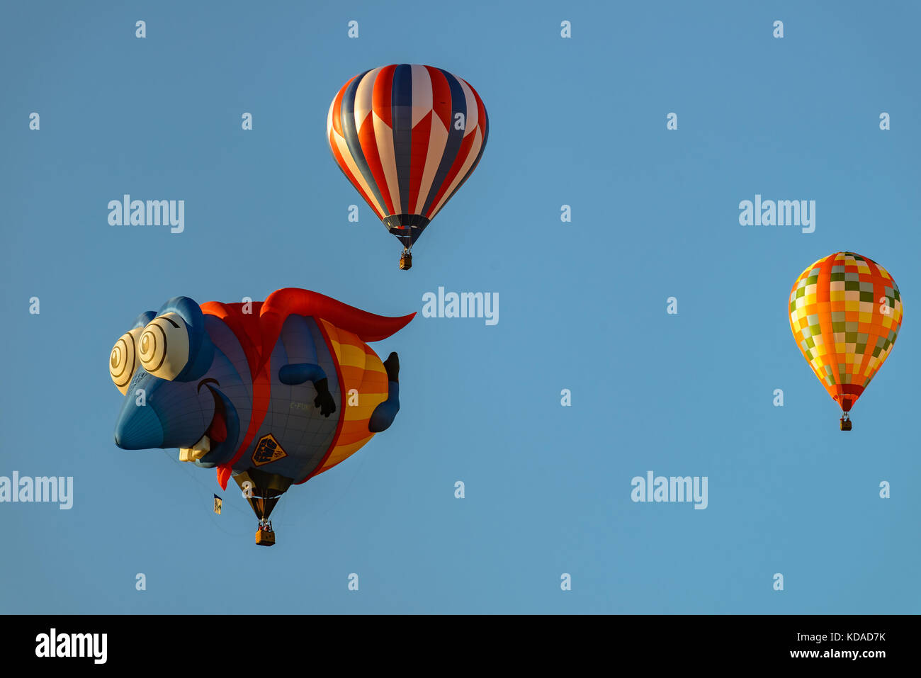 Colorful hot air balloons against blue sky Stock Photo