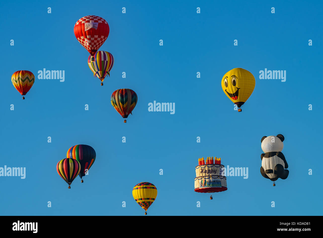 Colorful hot air balloons against blue sky Stock Photo - Alamy