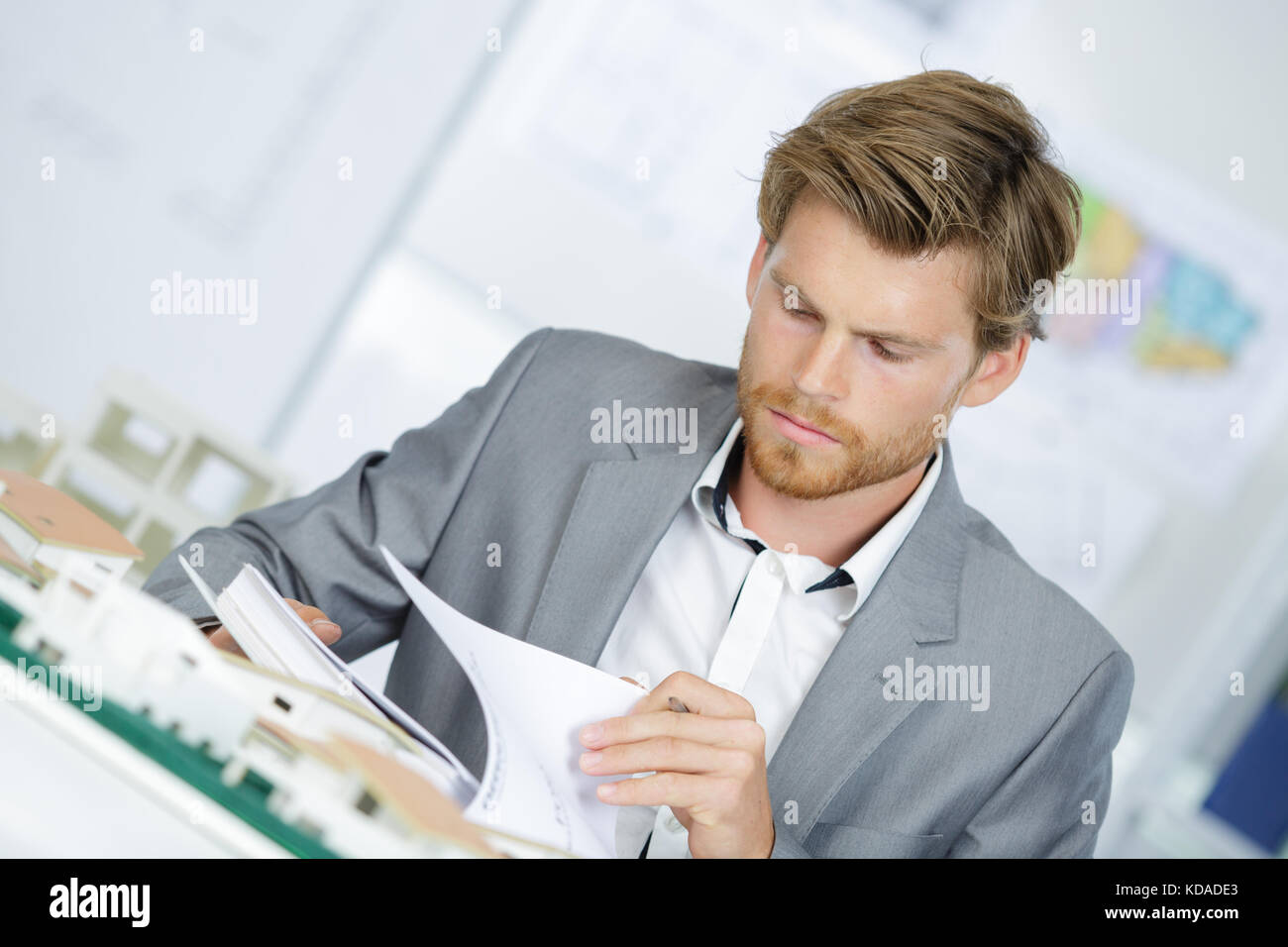 Model Guy Working Suited man working on model development Stock Photo - Alamy