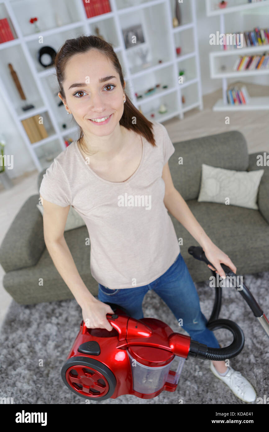 young woman with vacuum cleaner cleaning carpet at home Stock Photo - Alamy