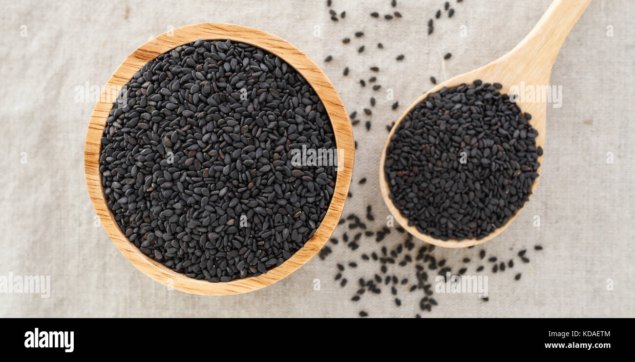 Black sesame in wood bowl from top view Stock Photo - Alamy