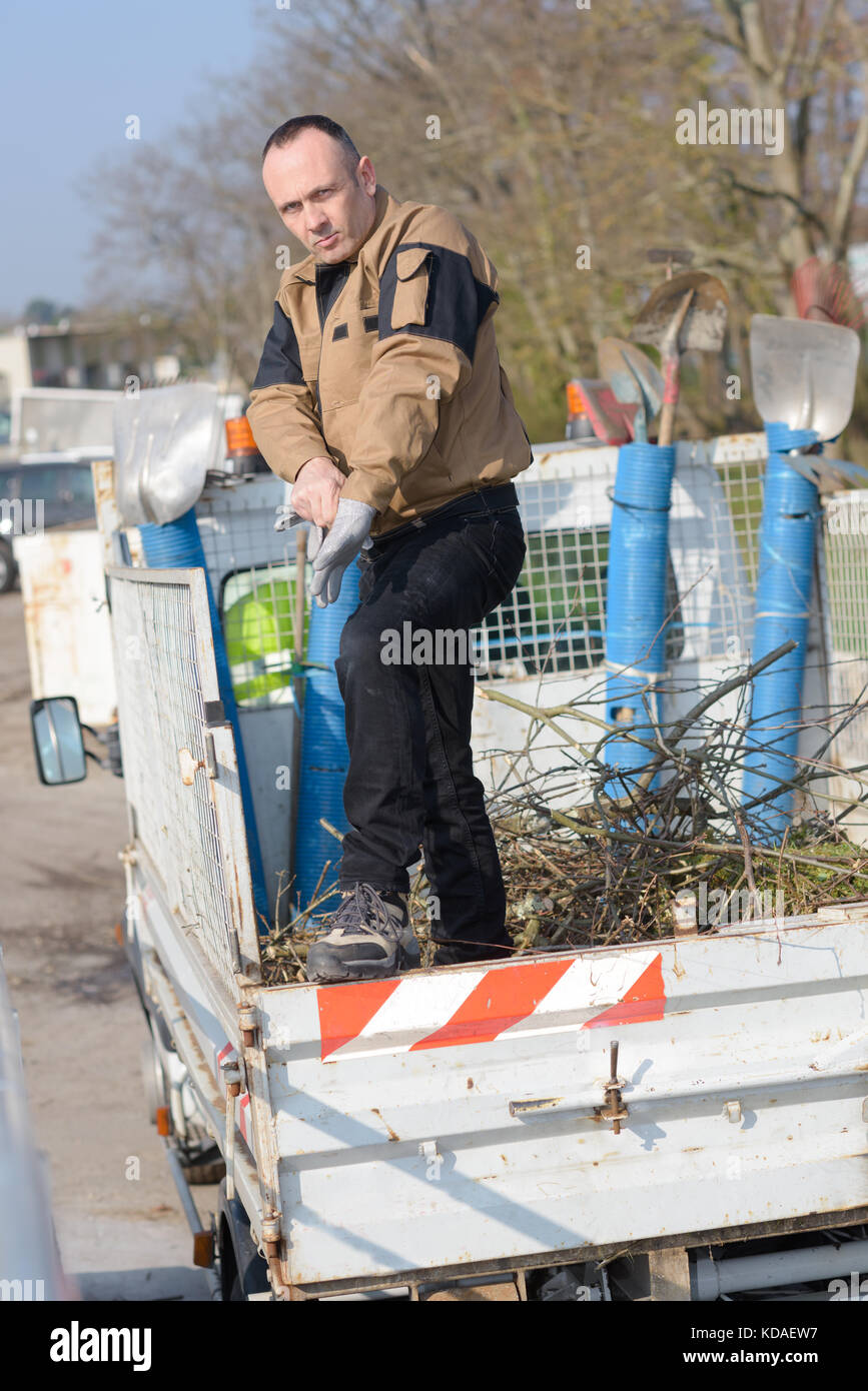 dustman cleaning a lorry bin Stock Photo