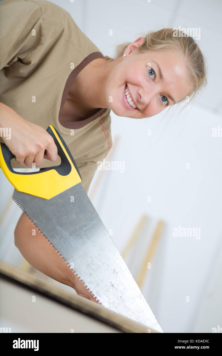 using a manual saw Stock Photo Alamy