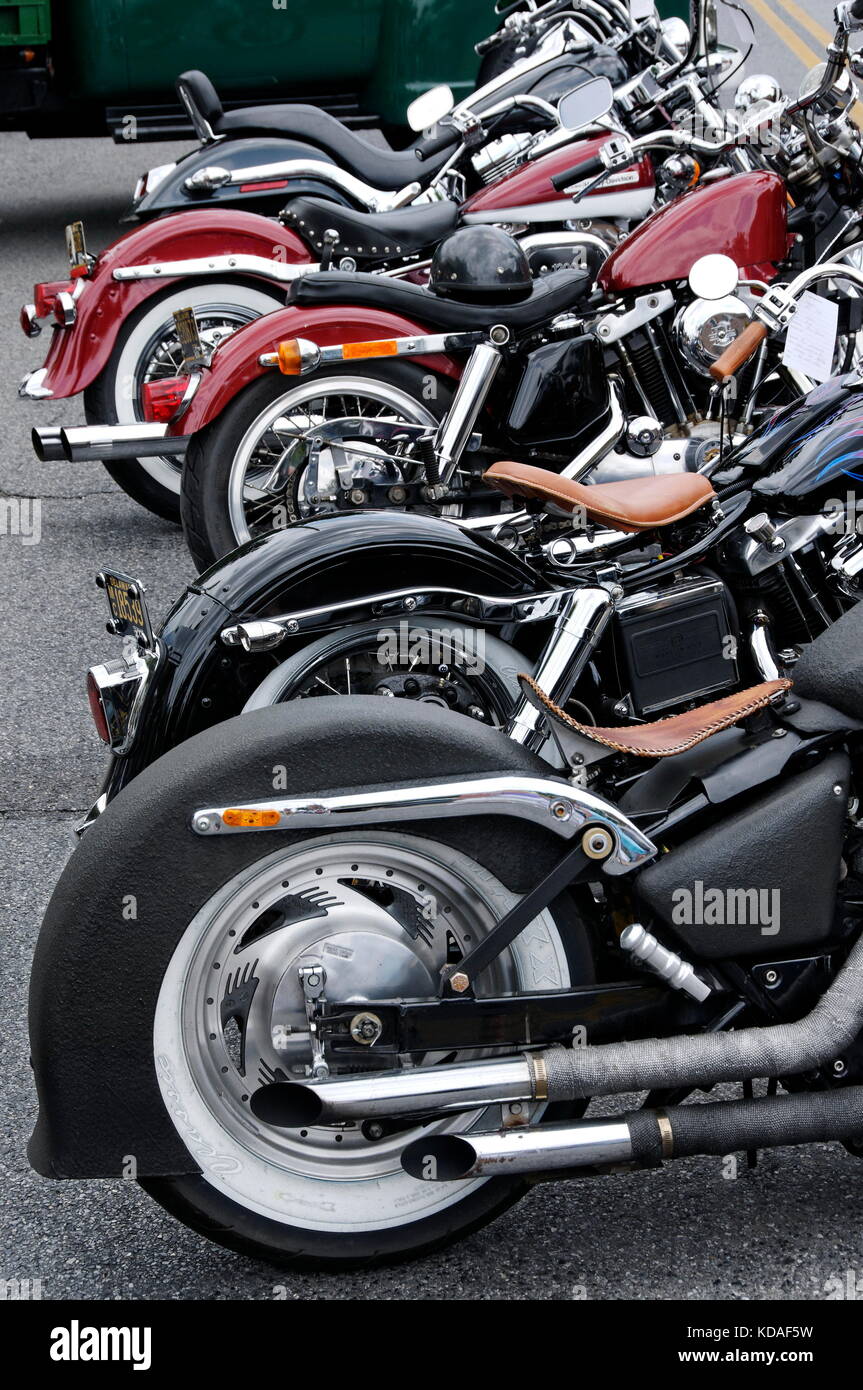 Rear axle view of multiple motorcycles parked in a row Stock Photo - Alamy