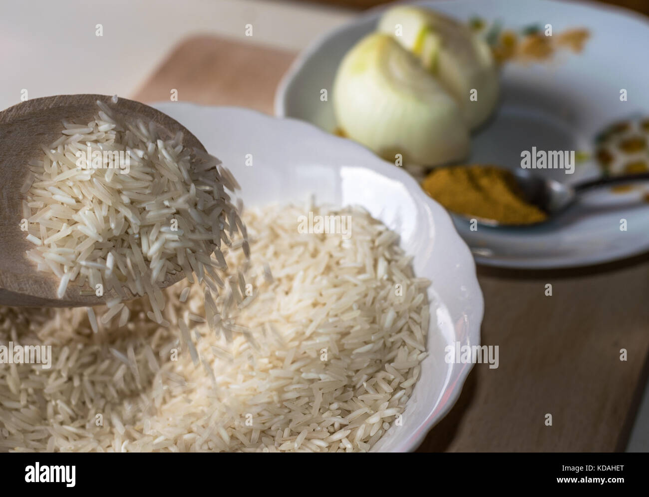 Basmati rice with curry powder and a sliced onion side view Stock Photo