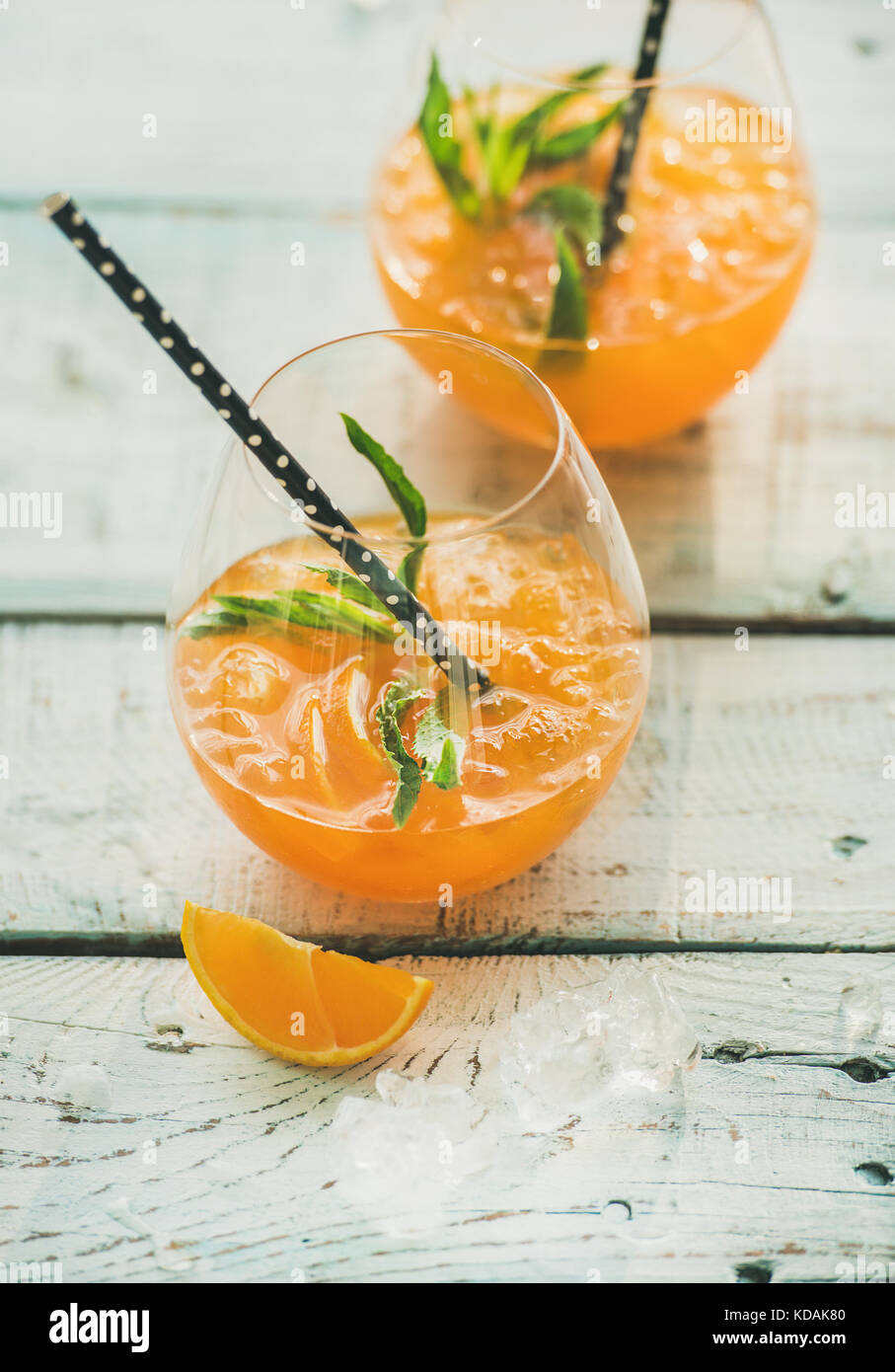 Refreshing cold alcoholic summer cocktail with orange in glasses Stock Photo