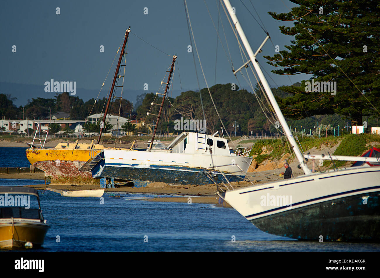 Grounded boats on the beach in Rockingham after winter storm Stock Photo