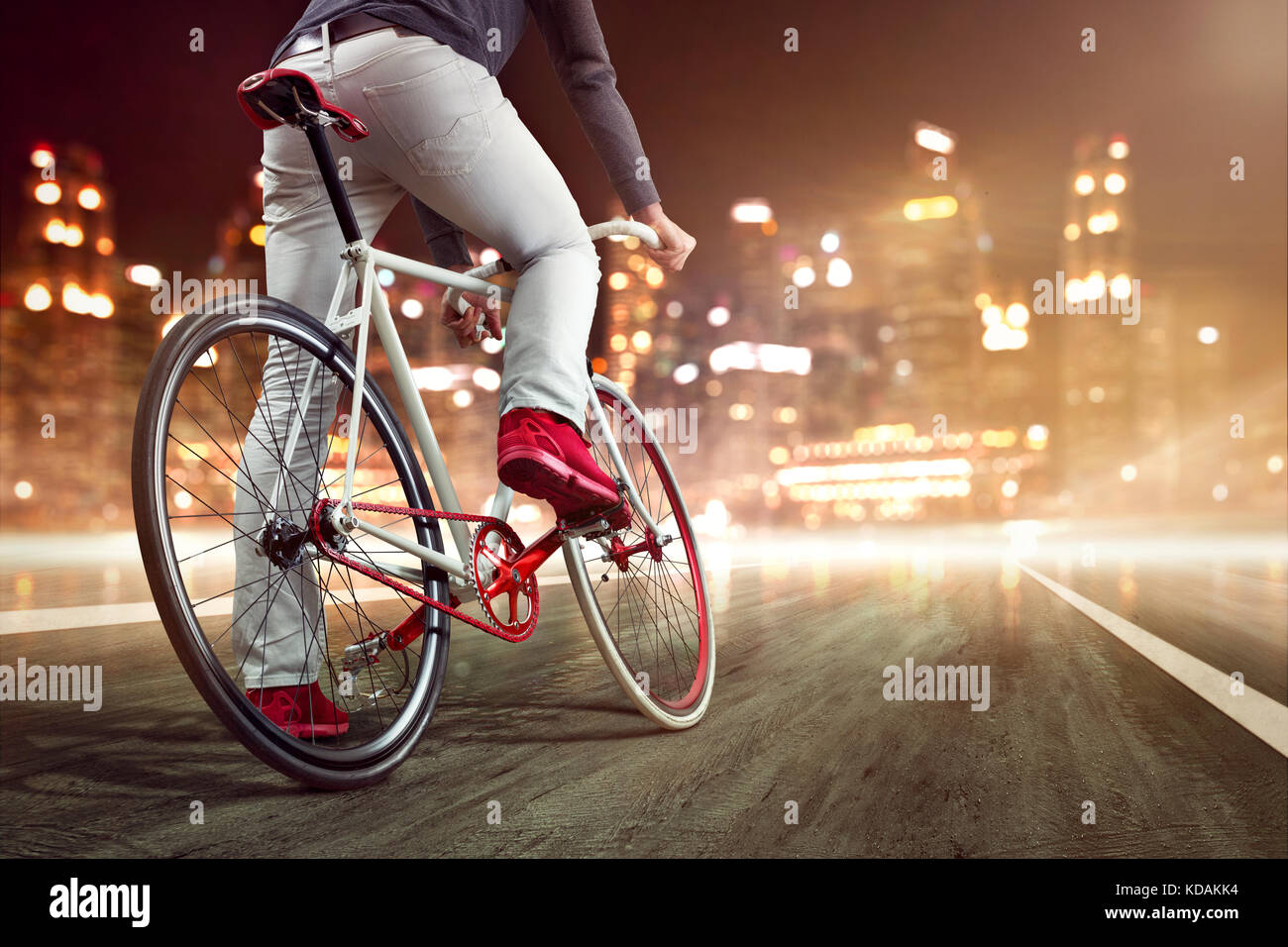 Modern bicycle in front of a nightly skyline Stock Photo