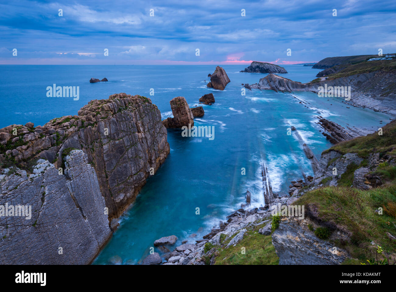 The rocks of Arnia beach in Cantabria during a sunrise Stock Photo