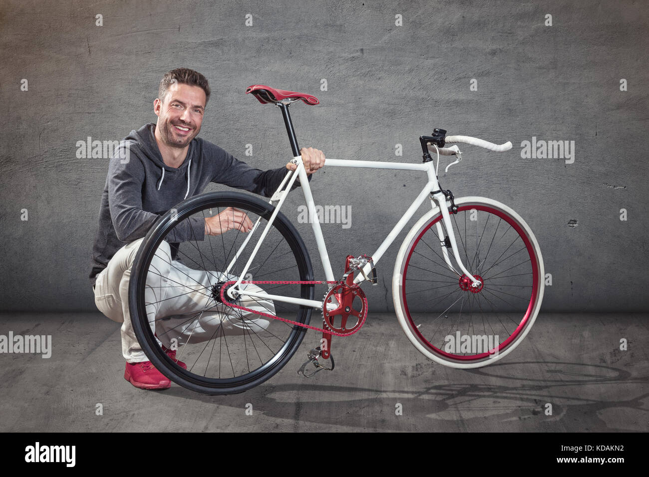 Happy cyclist next to custom made bicycle Stock Photo