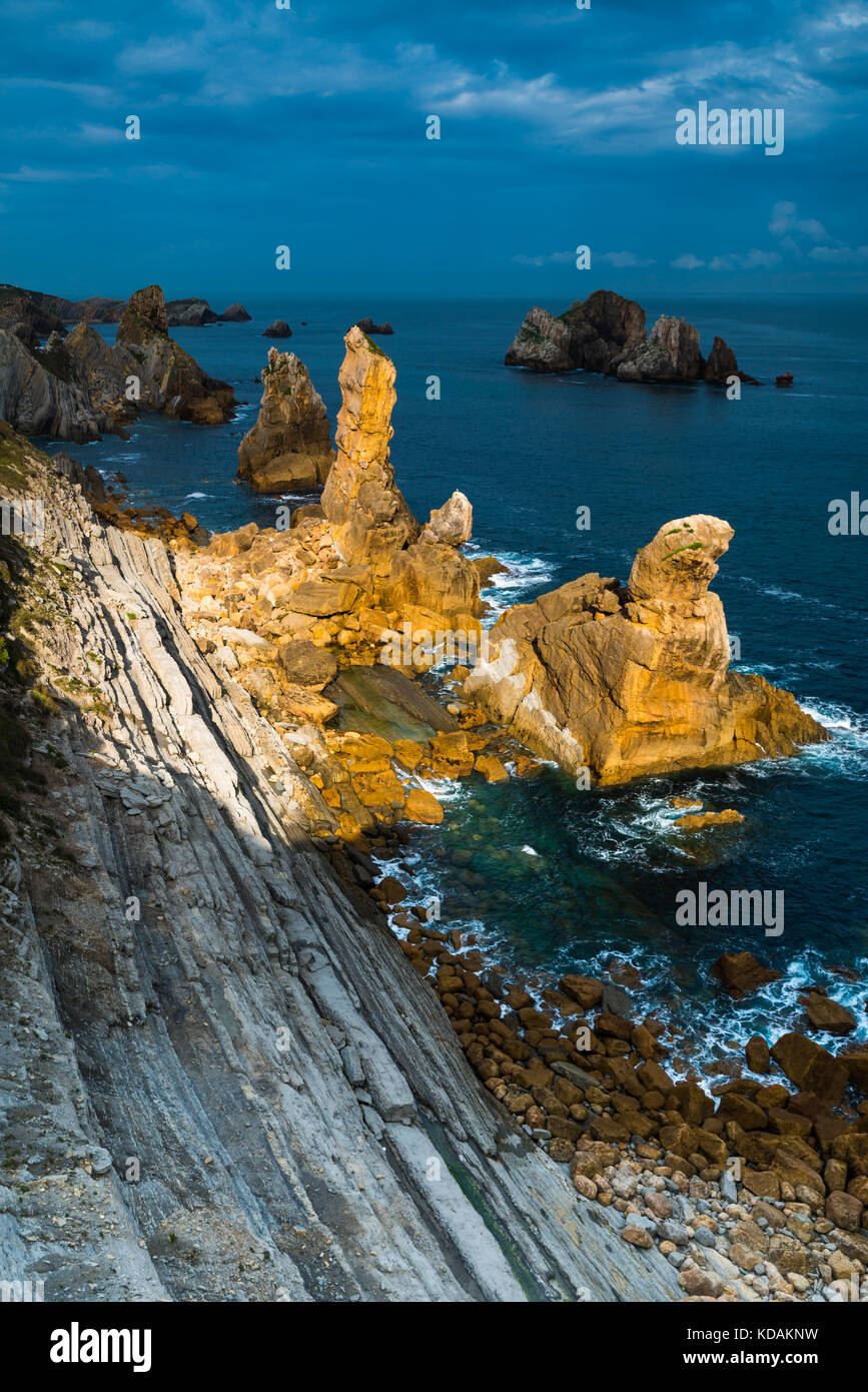 Sunlight illuminating a part of the rocky area at Urros area on Cantabria Stock Photo