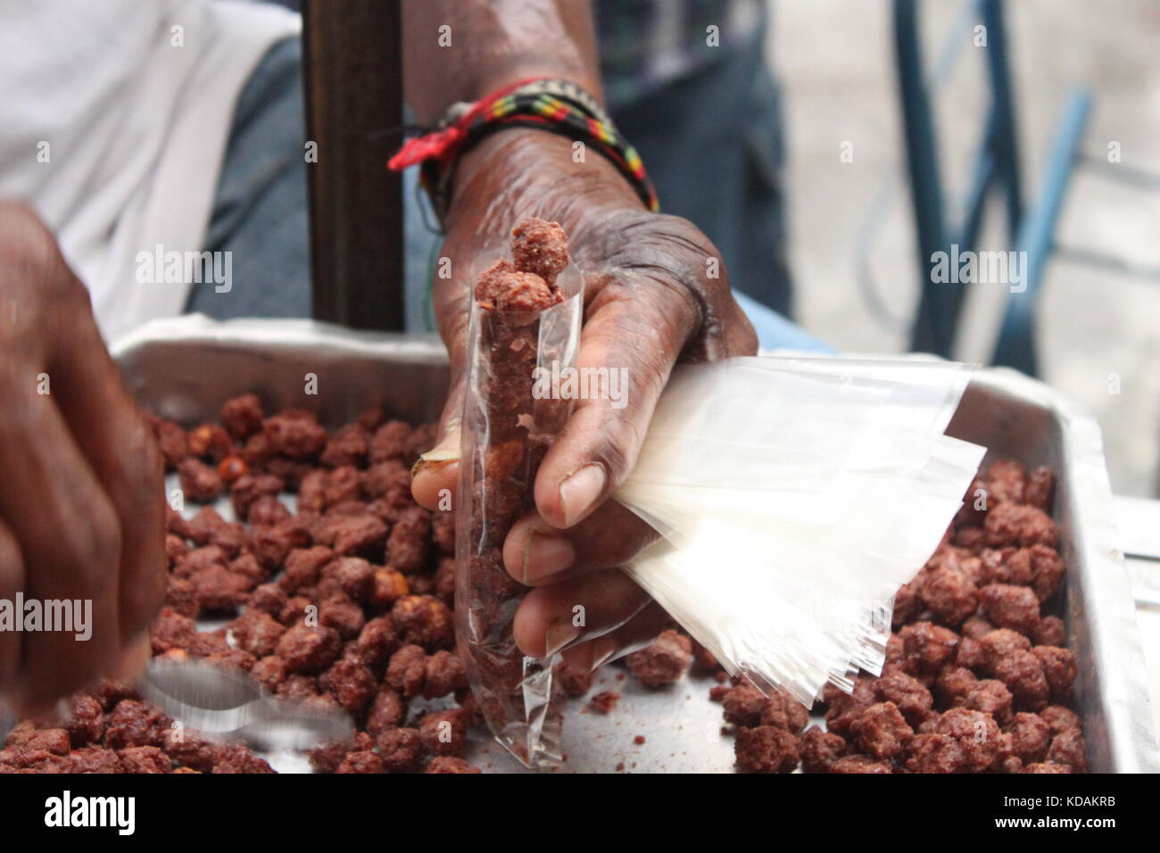 Brazilian street food vendor, packing sugar coated peanut Stock Photo