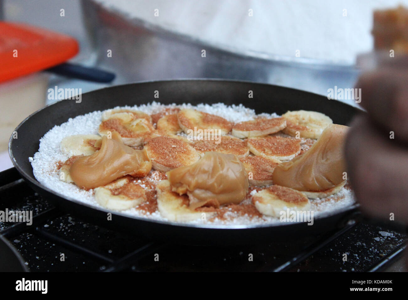 Brazilian street food: making of banana and dulce de leche tapioca Stock Photo