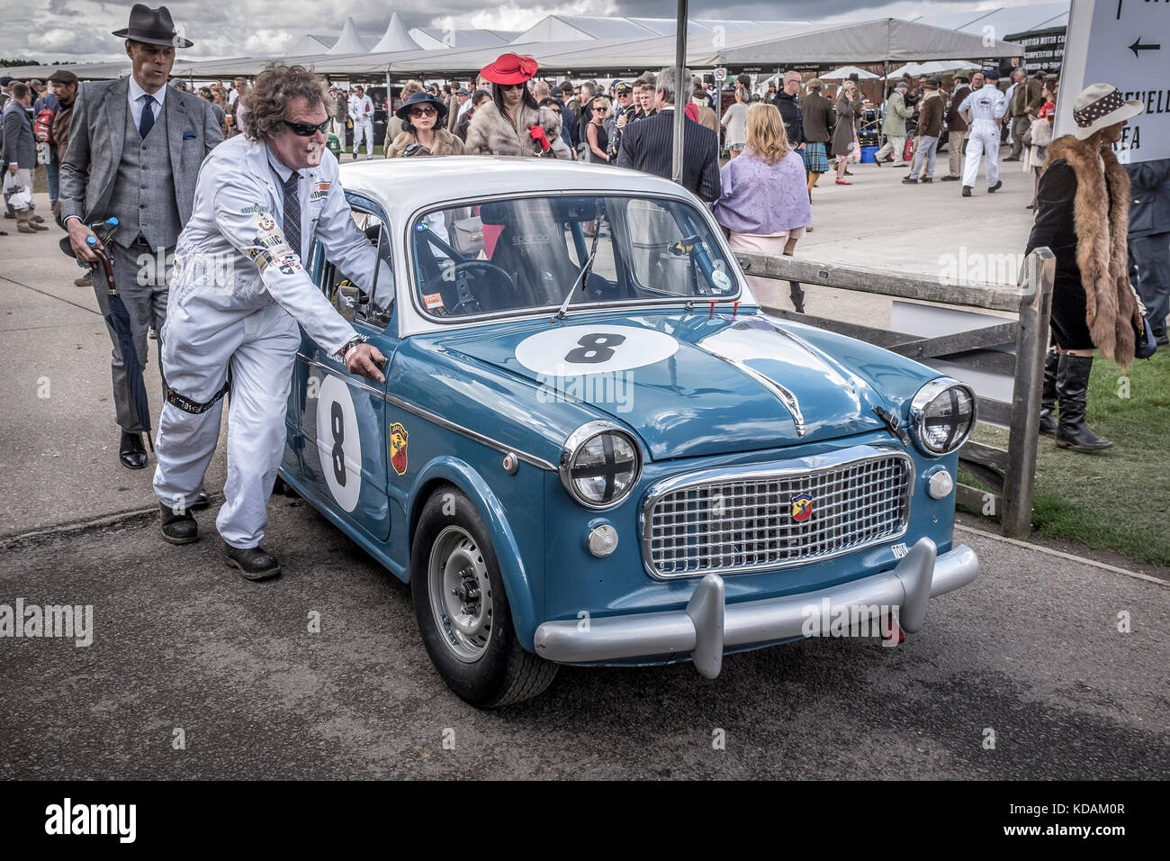Peter James' 1958 Fiat Abarth Evocation is pushed through the paddock at the 2017 Goodwood Revival, Sussex, UK. St Mary's Trophy entrant. Stock Photo
