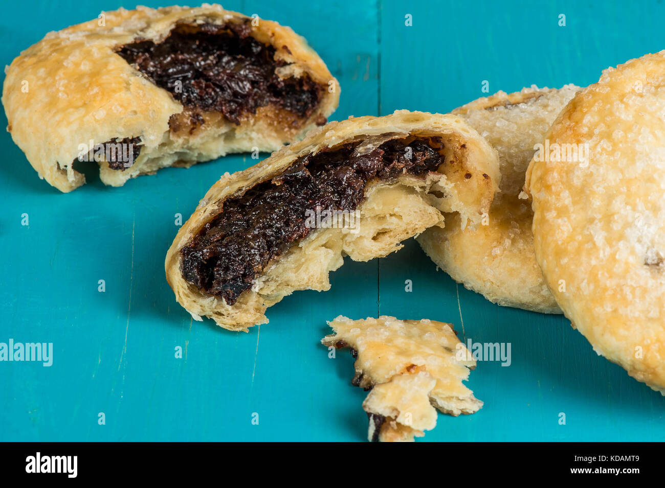 Puff Pastry Butter Eccles Cakes With A Currant Filling Against a Blue