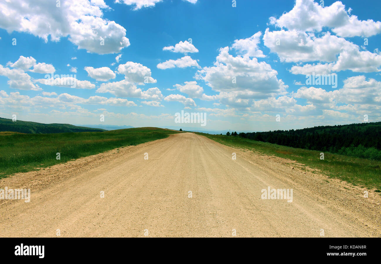 Blue sky with clouds and dirt road hi-res stock photography and images ...