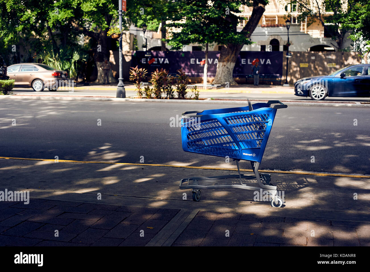 Abandoned Walmart shopping cart on the sidewalk of Paseo de Montejo avenue in Merida, Yucatan, Mexico Stock Photo