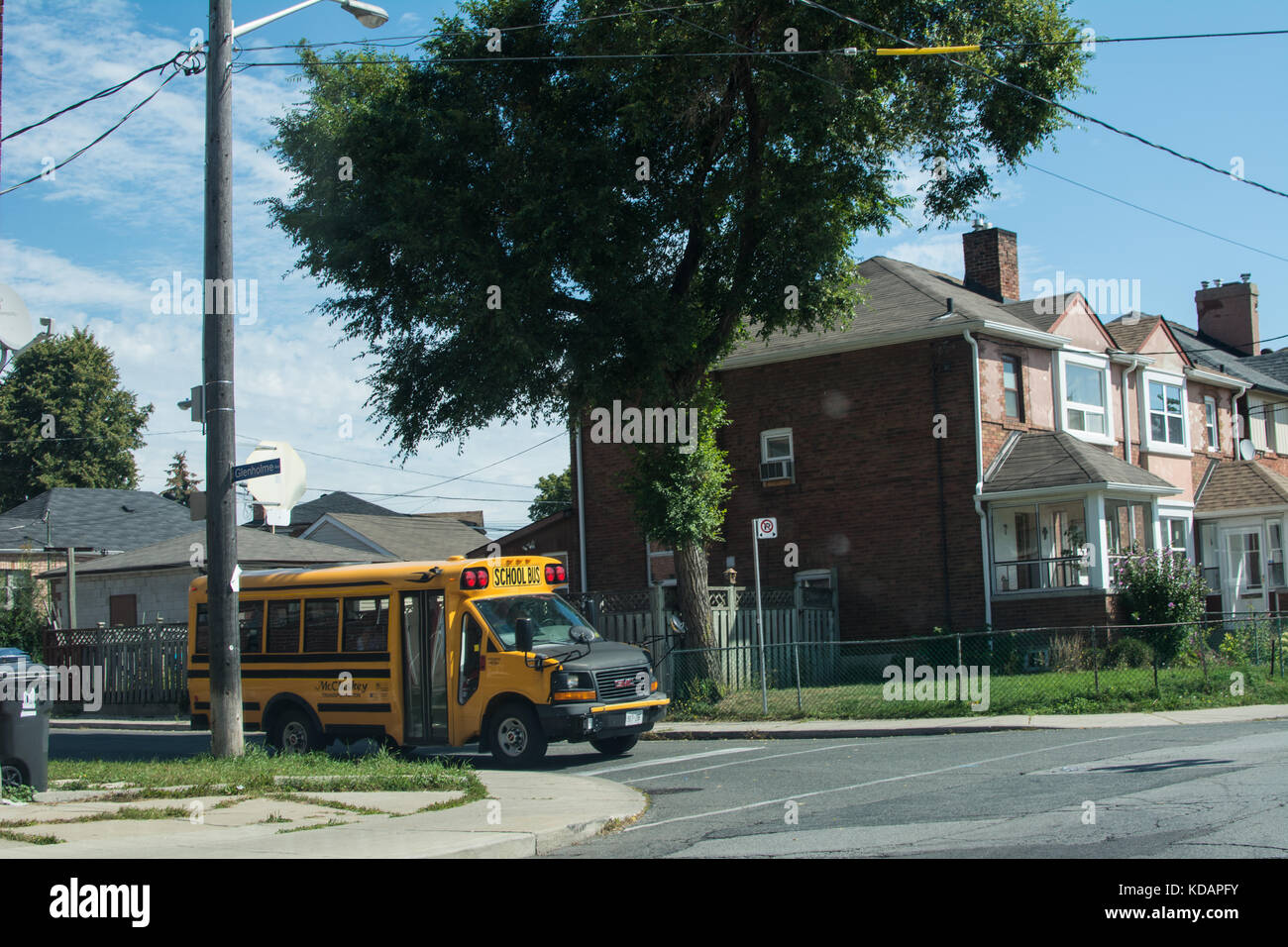 Yellow School bus Toronto Canada children's bus child leaving going to school  old type transport local locals estate collecting collect collected Stock Photo