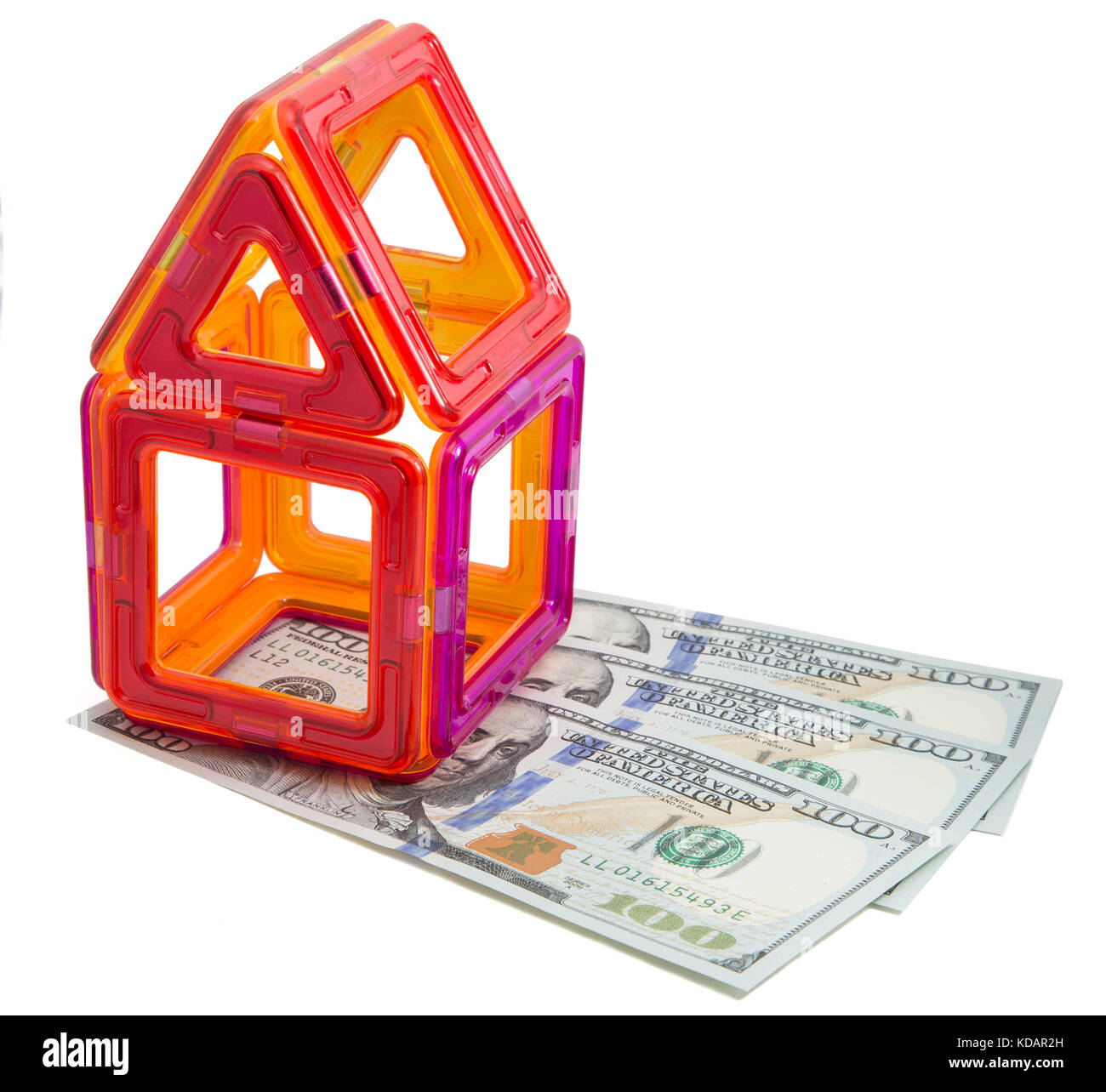 Toy house and money on isolated background Stock Photo