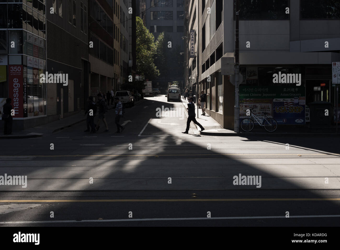 The shadow of a man walking through the modern city Stock Photo - Alamy